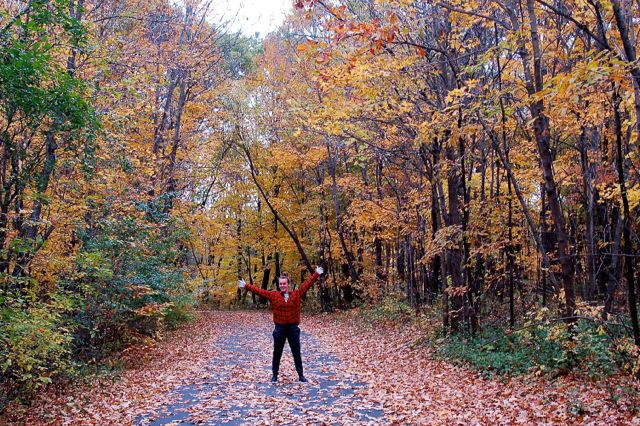 woman hiking amid fall leaves