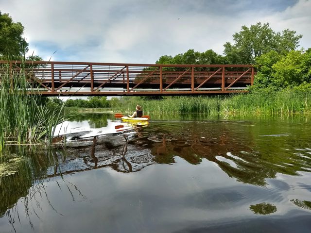 kayaking under a bridge