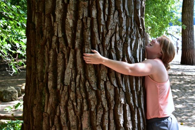 woman hugging a giant cottonwood tree