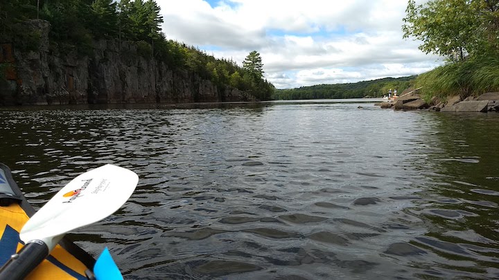 kayaking on the st. croix river with cliffs on the left