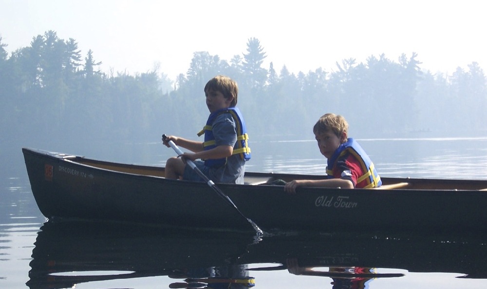 two young boys canoeing