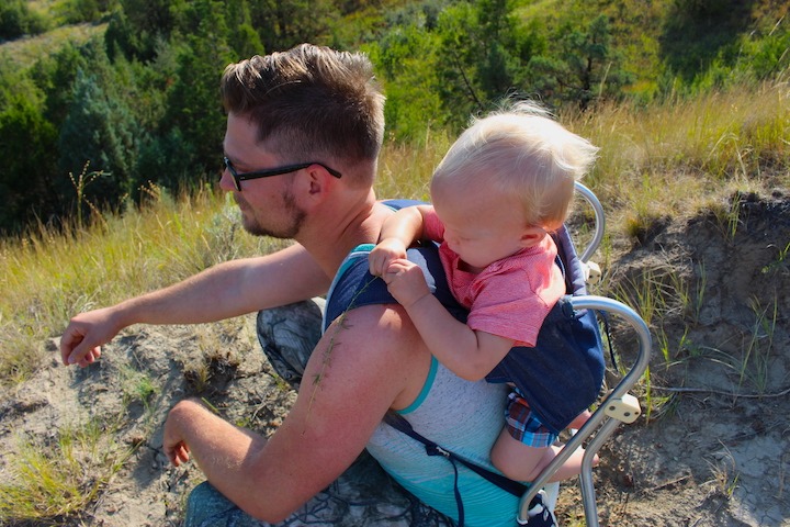 dad hiking with his baby in a backpack