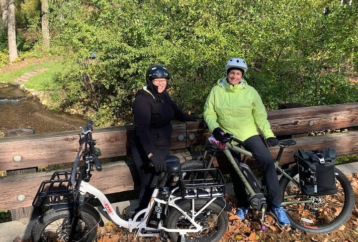 two women with electric bikes, resting during a ride
