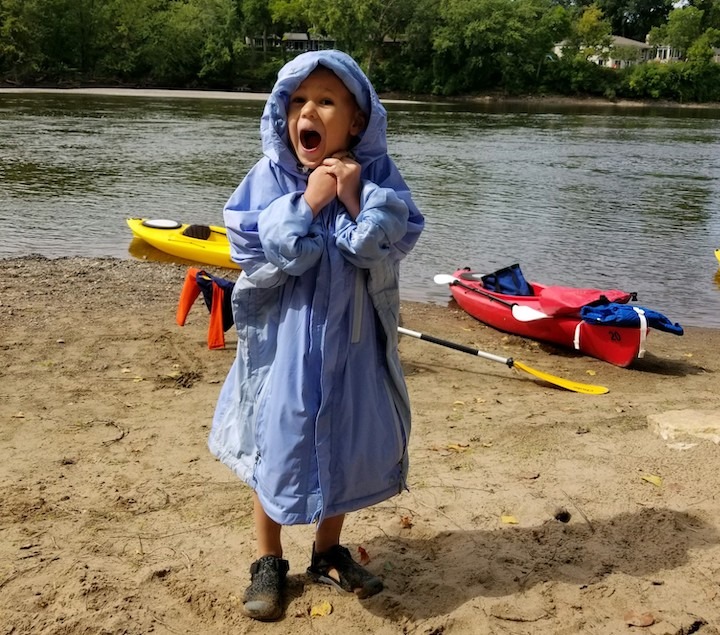 A young child having fun on a kayaking day