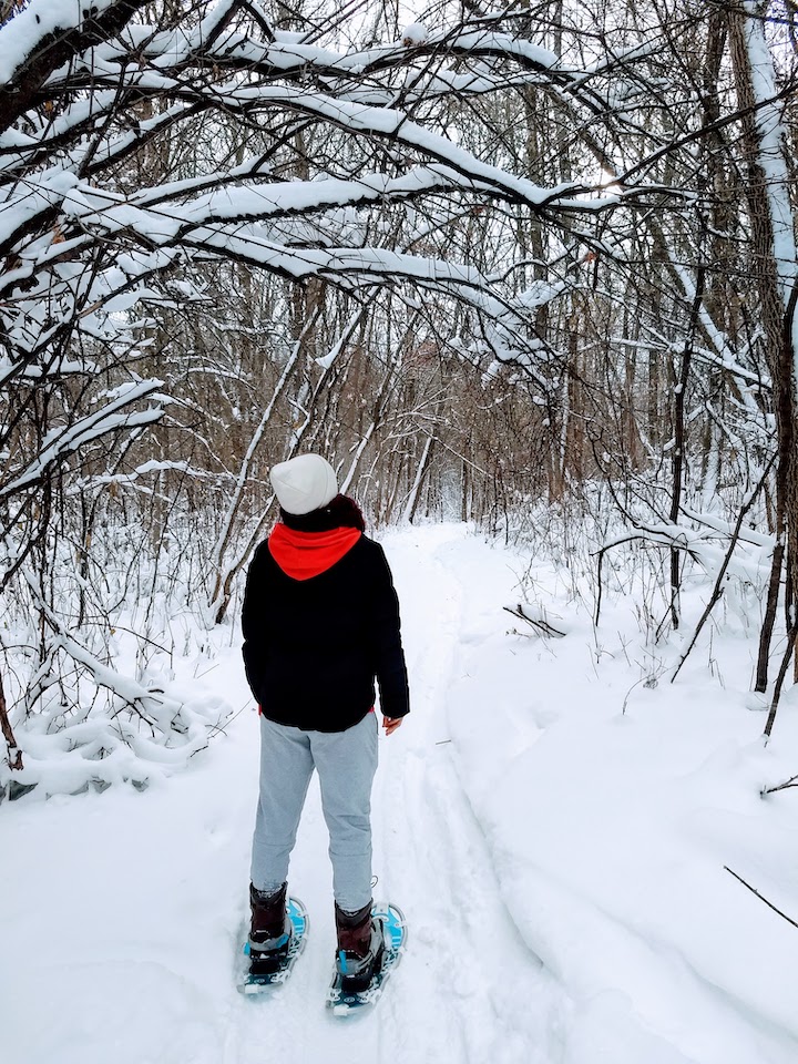 woman snowshoeing at elm creek singletrack park