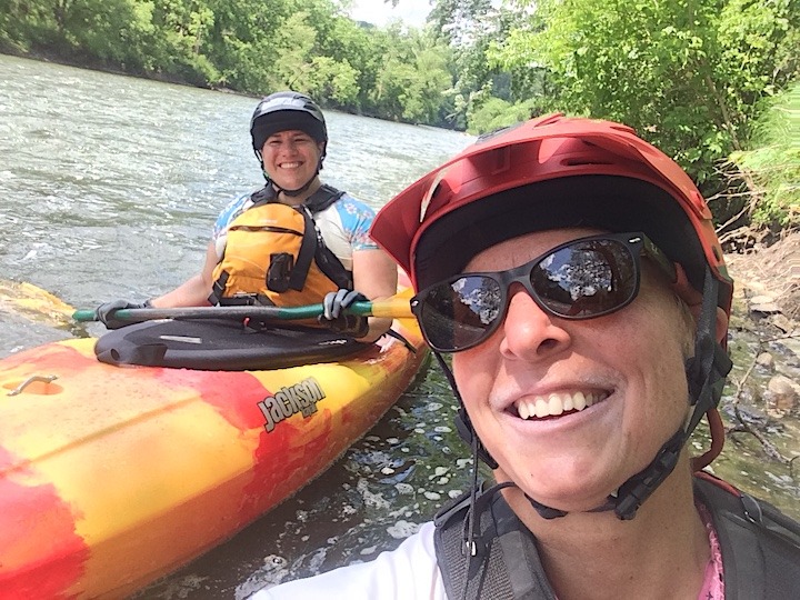 Over the Hill Outdoors owner, Natalie, with another kayaker on a local river
