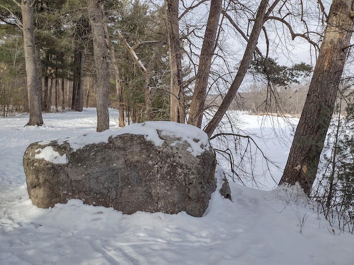 granite boulder on riverside trail