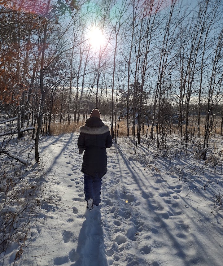 woman hiking on a sunny winter day