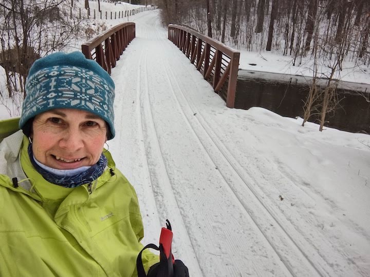 woman skiing, ready to cross a footbridge