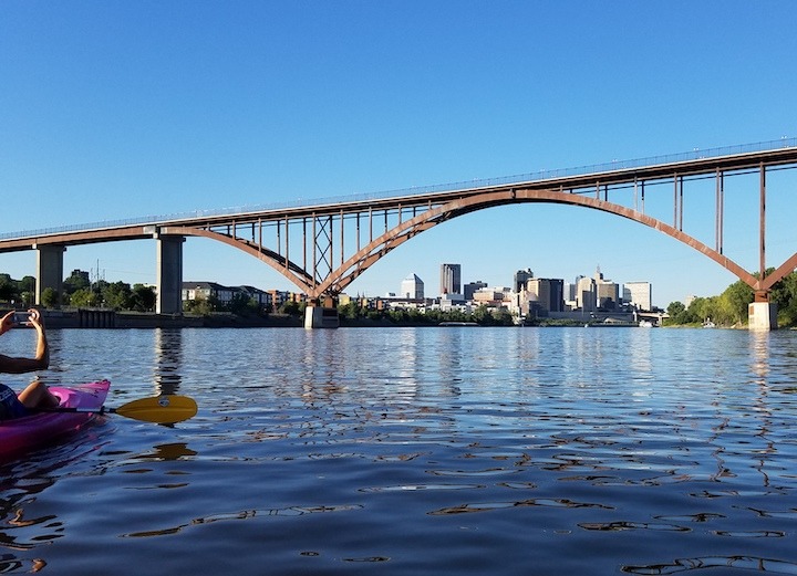 Saint Paul skyline seen through the bridge from a kayaker on the Mississippi River