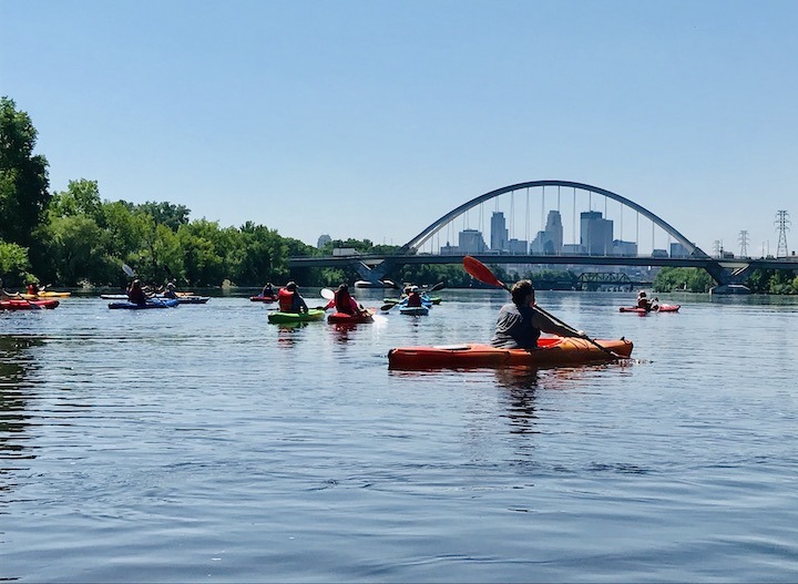 kayakers on Mississippi  River with Minneapolis skyline in the distance