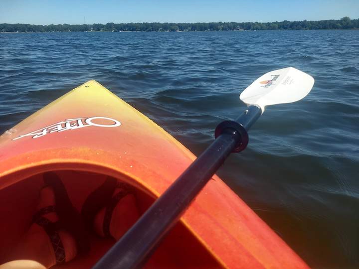 kayaking on Coon Lake, in an orange Otter kayak with Aqua Bound paddle, on a sunny day