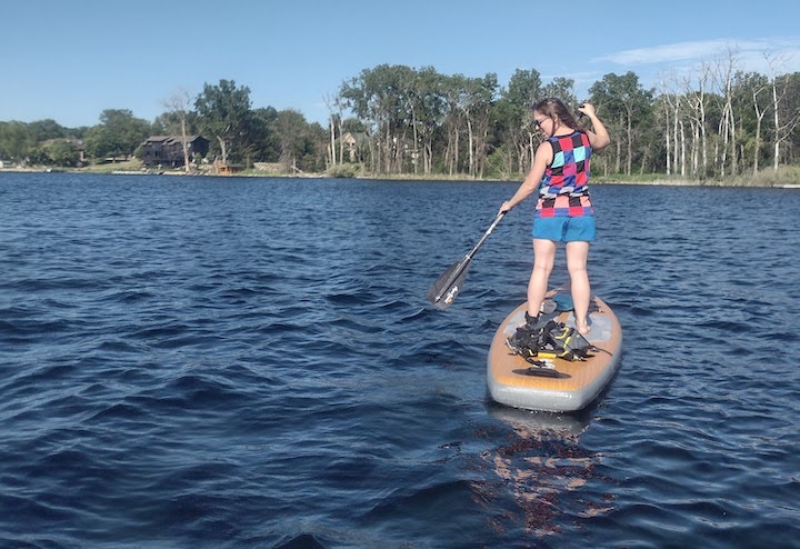 woman on a stand-up paddle board on Snail Lake