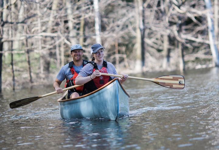 man and woman canoeing with Bending Branches paddles
