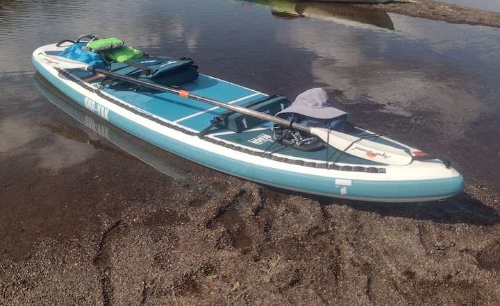 TAHE's inflatable Beach SUP-Yak sitting on a riverbank