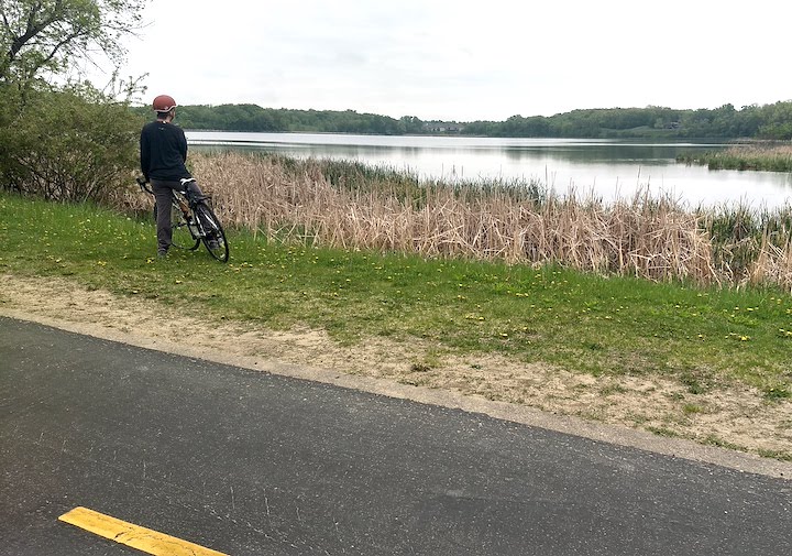 biker stops by a lake