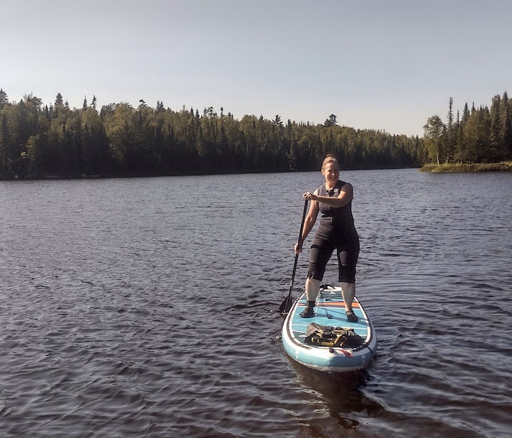 woman on a SUP board on a lake