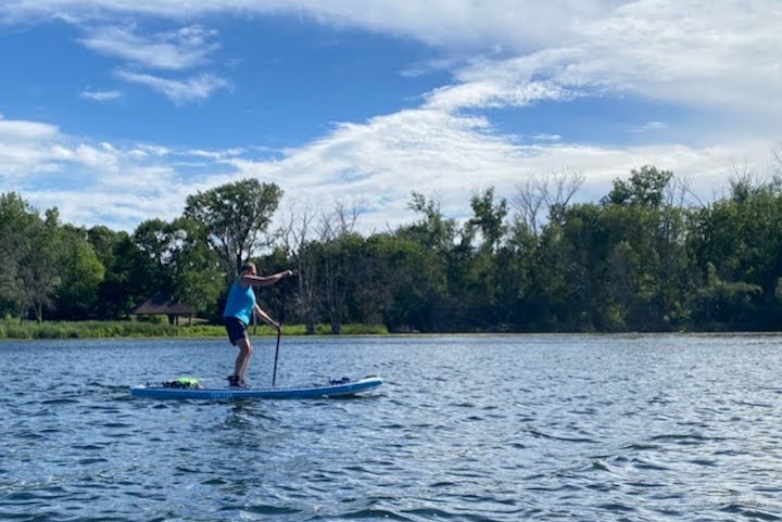 woman on SUP on a lake, paddling