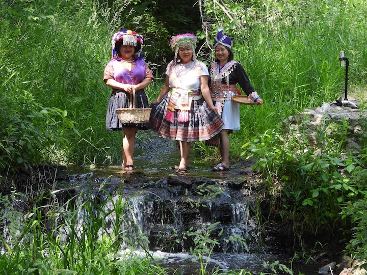 three Hmong women in Battle Creek in traditional apparel
